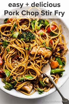 a white bowl filled with noodles, broccoli and chicken on top of it