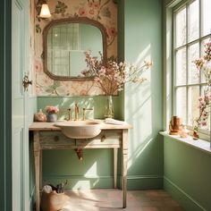 a bathroom with green walls and floral wallpaper on the walls, along with a white sink