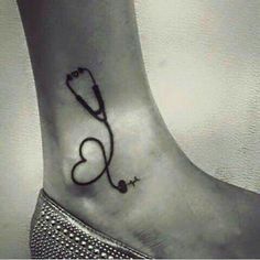 a small heart with a stethoscope tattoo on the side of her foot