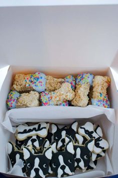 a box filled with lots of decorated cookies