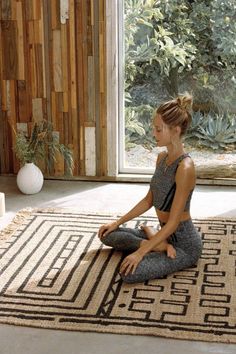 a woman sitting on the floor doing yoga