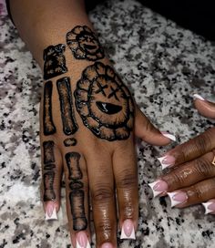 a woman's hand with tattoos on it