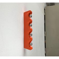 an orange light switch mounted to the side of a white wall