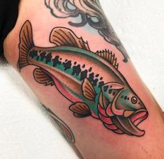 a colorful fish tattoo on the leg