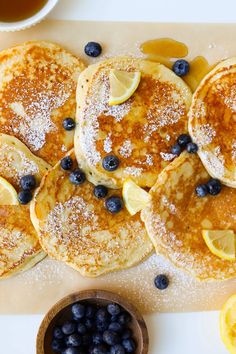 pancakes with blueberries and lemons on a cutting board