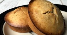 two muffins sitting on top of a white and black plate next to each other