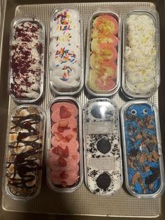 six containers filled with different types of ice cream and toppings on top of each other