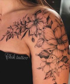 a woman's shoulder with flowers on it