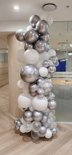 balloons are stacked on top of each other in the middle of an office lobby area