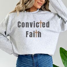 Convicted Faith Sweatshirt. This design promotes a message of hope and unity and reminds us that we can make a difference in the world!  .:These Gildan 1800 sweatshirts feel like your favorite well-loved sweatshirt.  Material  .: 50% cotton, 50% polyester .: Medium-heavy fabric (8.0 oz/yd² (271.25 g/m .: Loose fit .: Sewn in label .: Runs true to size .: Size up 2 sizes for an oversized fit  CARE INSTRUCTION: .:Turn garment inside out and wash cold on a delicate cycle. .:Tumble dry on low heat  .:Do not bleach, dry clean, or iron directly onto the design. Jesus Is My Savior, Faith Sweatshirt, Christian Crewneck, My Savior, Message Of Hope, Play Tennis, Jesus Is, Make A Difference, Sew-in Labels