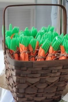 a basket filled with carrots sitting on top of a table