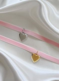 Oh it’s love... Introducing the most heavenly necklace to ever exist! Handcrafted with stunning pale pink velvet and your choice of a 14K gold or stainless steel heart locket, the 'FOREVER YOURS' is bound to become a treasured piece in your jewelry collection. Trust us, compliments are coming your way! Made with vintage, deadstock pale pink velvet and 14K gold plated or stainless steel locket. 45" length - designed to allow you to tie this piece in multiple ways. Handmade with love in Los Angele Pink Heart Locket Jewelry, Pink Heart Shaped Locket Jewelry, Dainty Choker Jewelry For Valentine's Day, Dainty Choker For Valentine's Day, Pink Charm Choker Necklace For Gift, Pink Heart-shaped Choker As A Gift, Pink Heart Choker As Gift, Pink Heart-shaped Choker For Gifts, Pink Heart-shaped Choker Gift