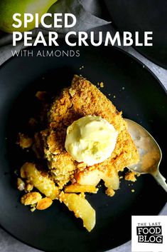 a close up of a plate of food with text overlay that reads spiced pear crumble with almonds