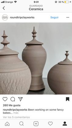 three vases sitting on top of a table next to each other