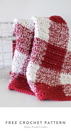 two red and white crocheted blankets sitting next to each other