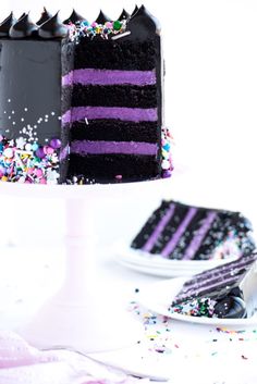 an image of a purple and black cake with sprinkles on the side