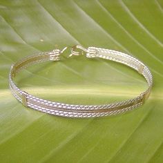 "A terrific little bracelet of six strands of wire--two plain 14kt gold filled wires on the inside, flanked by four sterling silver twist wires on the outside. Charming, comfortable, and feminine, and two-tone is really \"in\" right now! The sturdy built-in hook and eye clasp is easy to get on and off by yourself. This bracelet can also be made in all 14kt gold filled or all sterling silver. They would look AMAZING all three stacked together! Choose your size from the variations listed for a cus Gold Adjustable Double Strand Bracelet, Gold Wire Wrapped Multi-strand Jewelry, Gold Multi-strand Wire Wrapped Jewelry, Wire Wrapped Multi-strand Bracelets For Gifts, Multi-strand Wire Wrapped Bracelet As Gift, Gold Multi-strand Nickel-free Jewelry, Classic Gold Adjustable Braided Bracelets, Nickel-free Multi-strand Gold Jewelry, Gold Multi-strand Stackable Jewelry