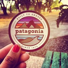 someone is holding up a sticker that says patagonia