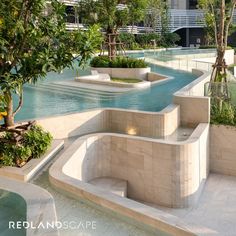 an outdoor swimming pool surrounded by trees and plants