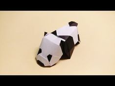 an origami panda bear sitting on top of a table