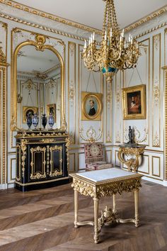 an ornately decorated room with gold and white decor