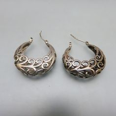 These lovely vintage Sterling silver saddle back closure style earrings are delicate with their pierced metal design.  They measure 1 1/8th inch high and 3/8ths inches wide across the widest point.  They are in MINT condition and marked, 925 on the post.   We will send these to you in a lovely gift box for easy gift giving or safe storage. If you like vintage bolo ties, western accessories, Native American jewelry and vintage costume jewelry, kindly check out my Etsy store at www.etsy.com/shop/PANPDF Metal Huggie Earrings For Formal Occasions, Classic Silver Pierced Huggie Earrings, Formal Metal Huggie Earrings For Pierced Ears, Classic Silver Huggie Pierced Earrings, Ornate Hoop Jewelry For Pierced Ears, Filigree Metal Earrings For Anniversary, Nickel-free Metal Hoop Earrings For Formal Occasions, Silver Metal Huggie Earrings For Formal Occasions, Ornate Round Earrings For Anniversary