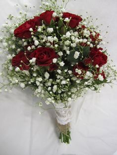 a bouquet of red roses and white baby's breath