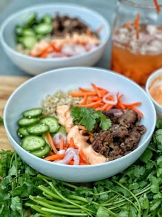 three bowls filled with different types of food on top of a cutting board next to sauces and seasonings