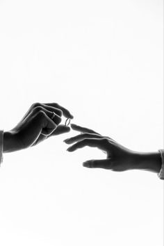 two hands reaching out towards each other to touch something in the air with their fingers