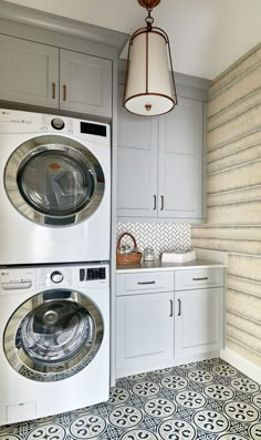 a washer and dryer sitting in a kitchen next to each other on top of cabinets