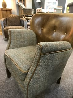 a brown leather chair sitting on top of a carpeted floor