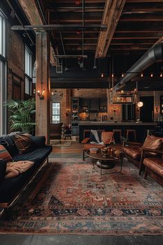 a living room filled with furniture and lots of windows next to a large rug on top of a wooden floor