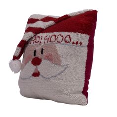 a red and white pillow with santa claus on it's face, which says school