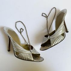 Authentic vintage early 2000s Givenchy metallic silver high heel sandals have beautiful raised curves across the toe area and silvertone chain link slingbacks. Made in Italy.  These have been well loved - still a lot of life left with a some attention - overall wear to uppers and insoles as shown, deep scuffing mostly to the heels and to the toe are of insoles, light tarnish on the chains.  Marked a 37.5; look to be a 6.5-7ish but please compare with a pair of your own shoes for reference. 9 7/8 Vintage Silver Heels For Evening, Silver High Heels With Chain Strap, Silver Vintage Heels For Party, Givenchy Paris, Slingback Heels, Slingbacks, Silver Shoes, Slingback Heel, Vintage 2000s