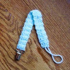 a crocheted white lanyard on a wooden table