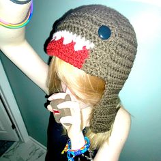 a woman wearing a knitted hat and holding a cell phone up to her ear