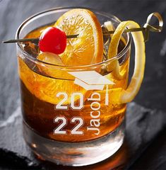 a close up of a drink in a glass with an orange slice on the rim