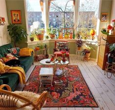 a living room filled with furniture and lots of plants in the window sills