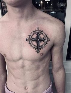 a man with a cross tattoo on his chest