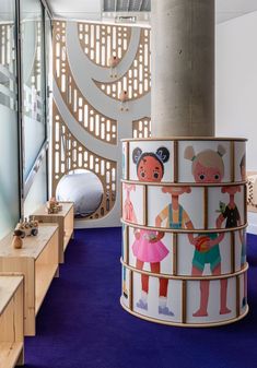 the children's play area is decorated with colorful murals and wooden steps leading up to an indoor climbing wall