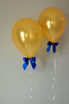 two yellow balloons with blue bows hanging from the ceiling, and an instagram post about them