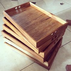 a stack of wooden boxes sitting on top of a tile floor next to a pair of scissors