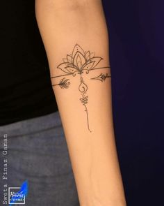 a woman's arm with a tattoo on the wrist and an arrow in the middle