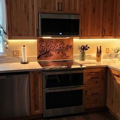 a kitchen with wooden cabinets and stainless steel appliances