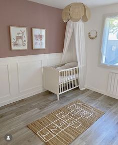 a baby's room is decorated in pink and white