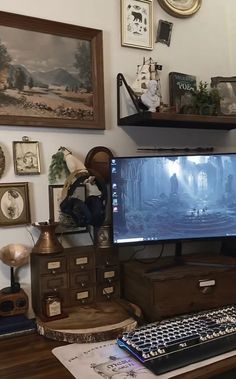 a computer monitor sitting on top of a wooden desk next to a keyboard and mouse