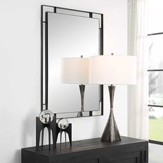 a table with a lamp and mirror on it