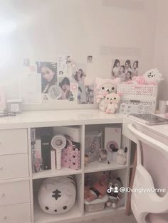 a white desk topped with lots of drawers and pictures on the wall next to a sink