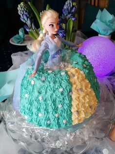 a frozen princess cake with frosting and flowers