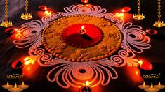 an intricately decorated diya with lit candles